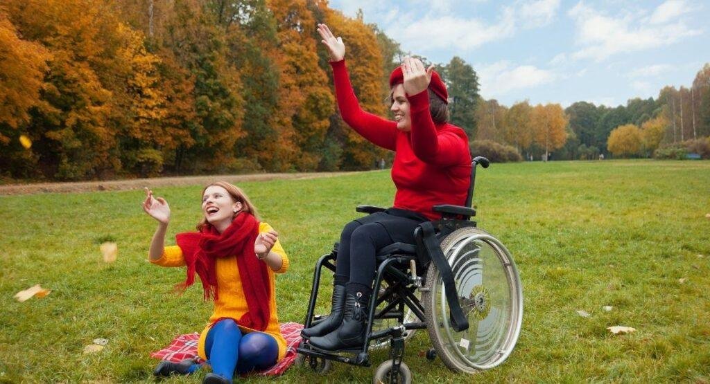 Who we support – young people enjoying time outdoors, including a wheelchair user.